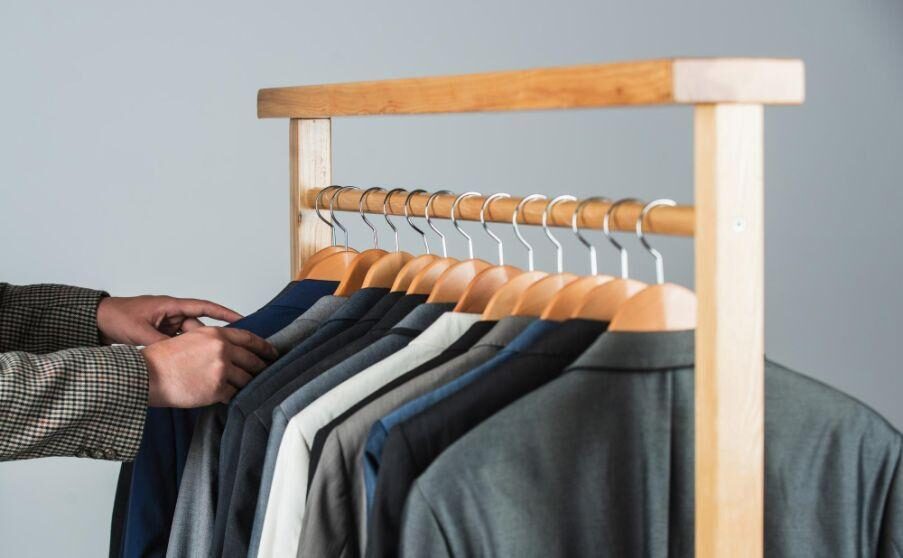 male-fashion-designer-individual-measures-hand-man-man-ordering-business-suit-posing-indoor-tailor-measures-man-stylish-business-man-workspace-fashion-design-studio
